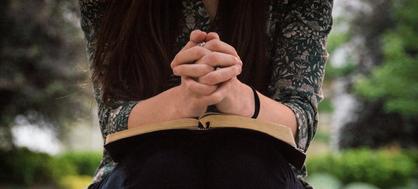 person sitting while reading book